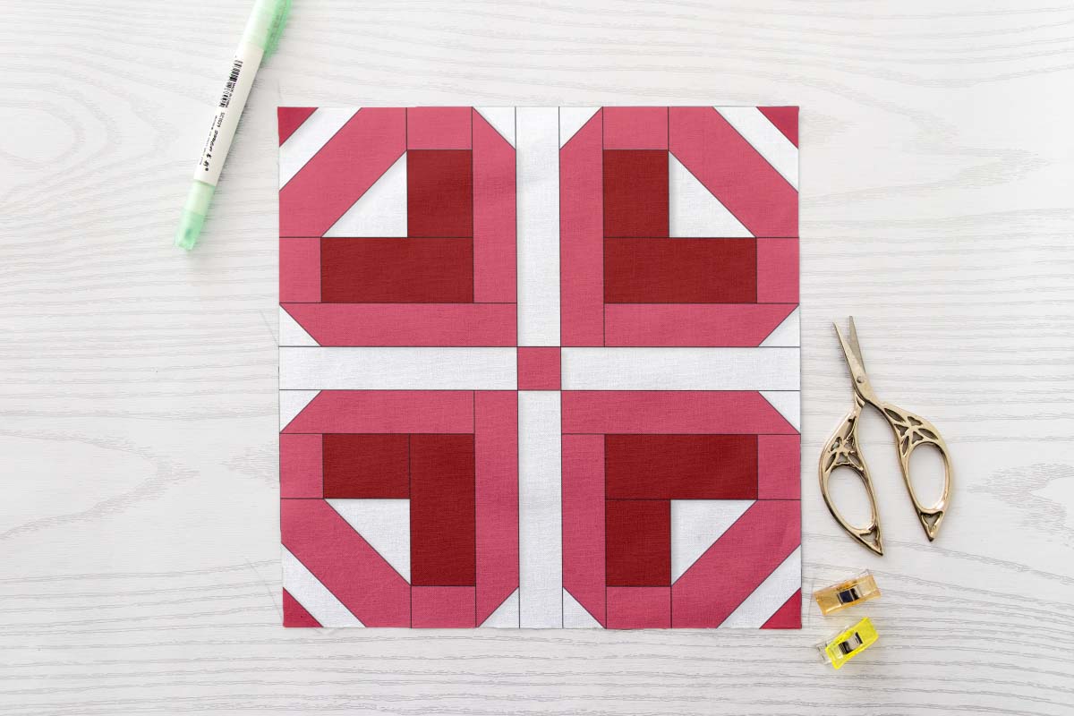 Four Petal Heart FPP Quilt Block Pattern PDF - Pink and Red Floral Quilt Block with Four Heart Shaped Petals on White Background